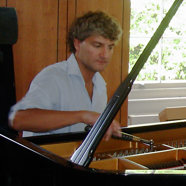Tim Hendy tuning a grand piano for a private client
