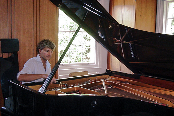Tim Hendy tuning a Steinway Grand for a private client