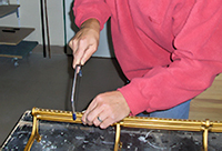 Tim Hendy Pianos workshop, cutting a split Steinway action rail prior to removal