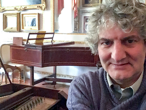Tim Hendy tuning at the Cobbe Collection surrounded by antique pianos